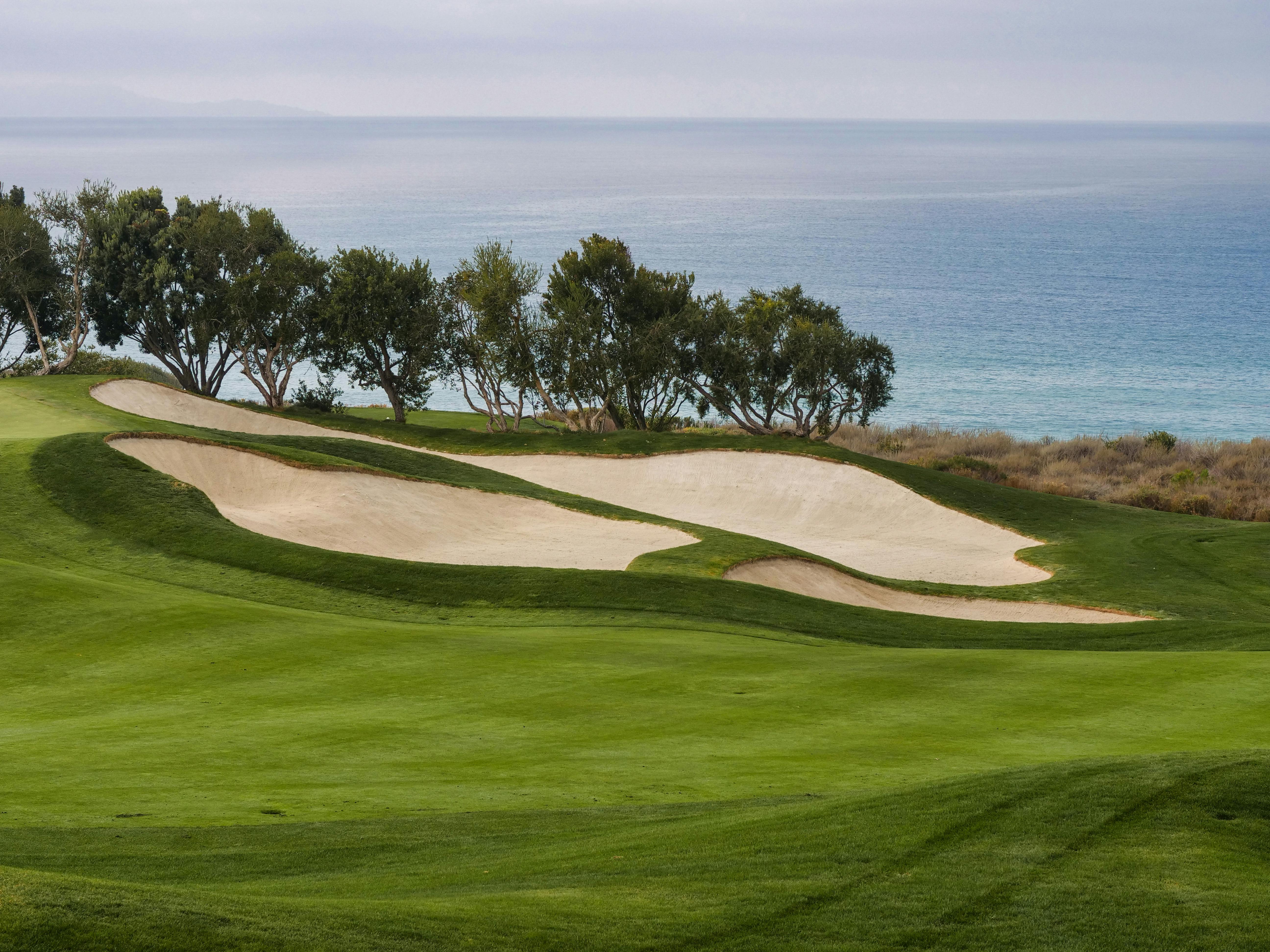 Golf course with beach in the background