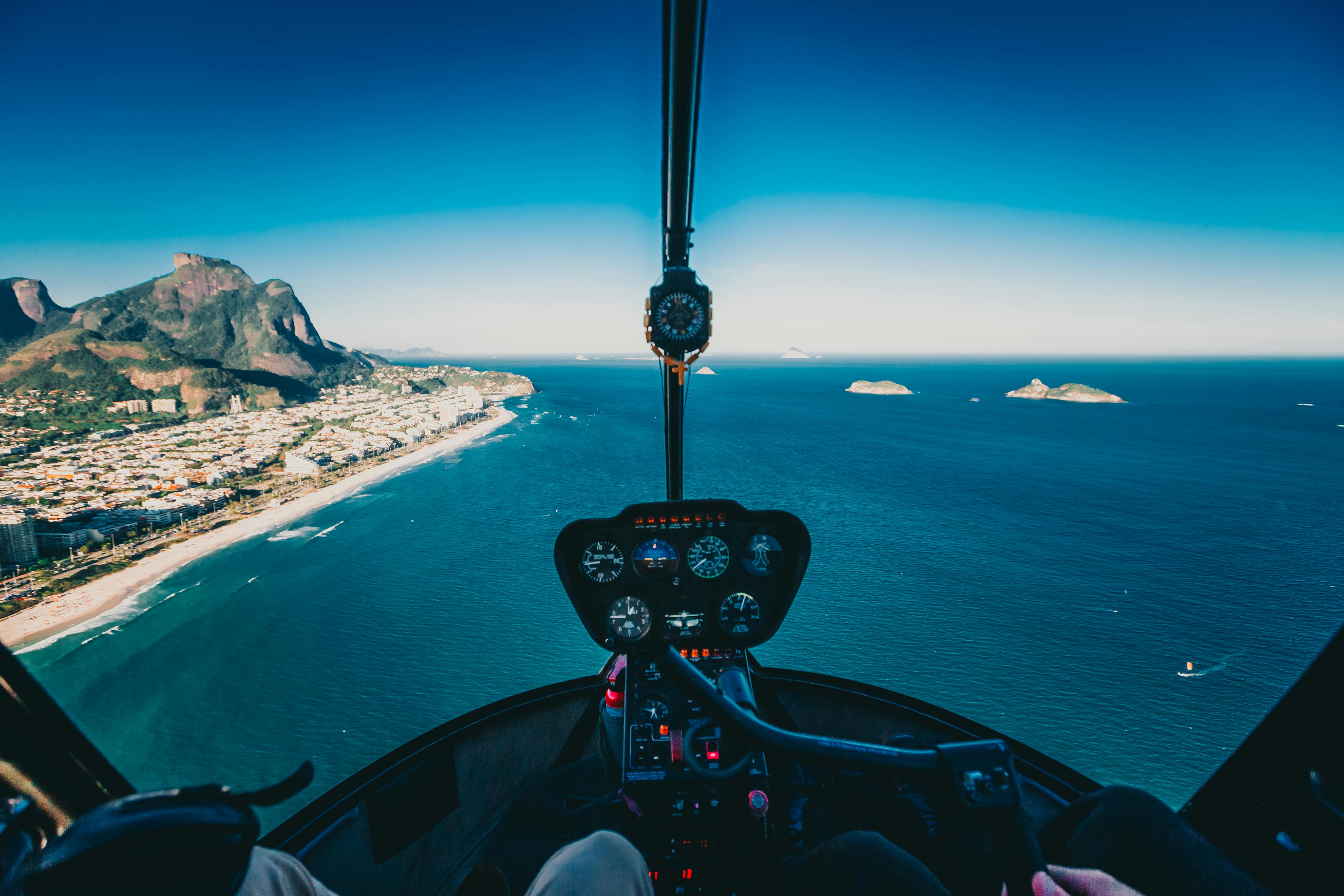 Photo of person flying a helicopter from inside the cockpit